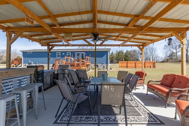 view of patio featuring an outdoor hangout area, outdoor dining area, and fence