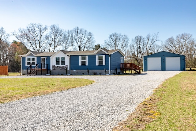 ranch-style house featuring crawl space, a garage, an outdoor structure, and a front yard