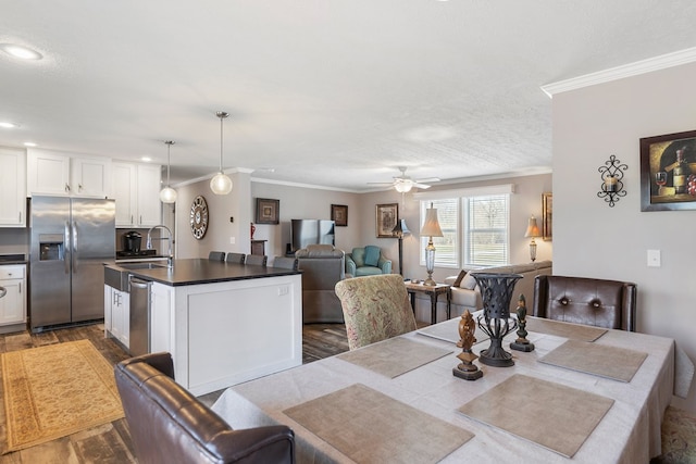 dining room with crown molding, a ceiling fan, and dark wood-style flooring