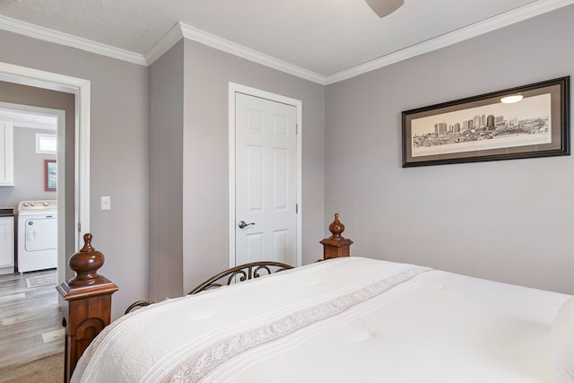 bedroom with ornamental molding, wood finished floors, a ceiling fan, and separate washer and dryer