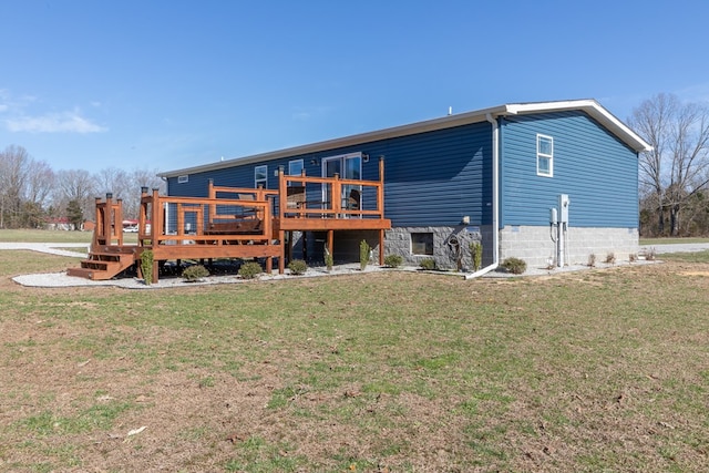 rear view of house featuring a lawn and a deck