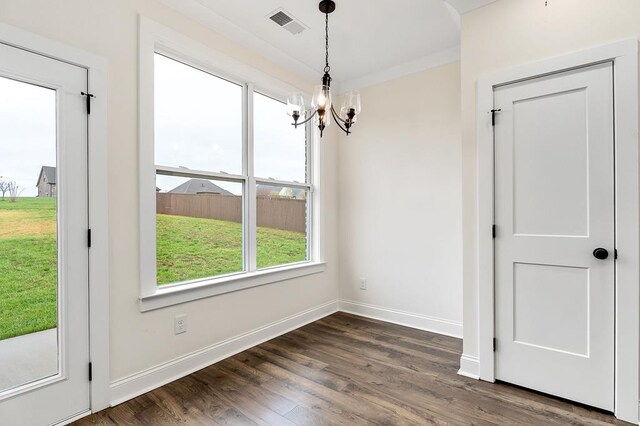 living area featuring visible vents, a raised ceiling, dark wood-type flooring, crown molding, and a fireplace