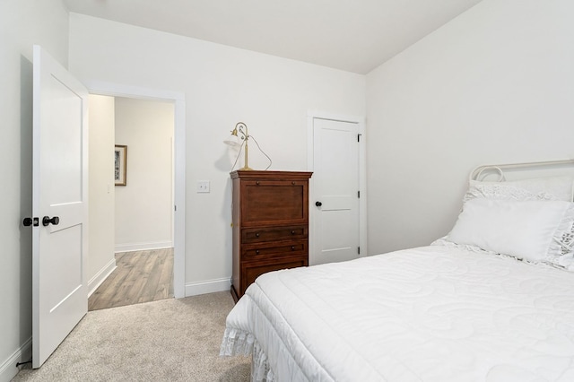 bedroom featuring carpet flooring and baseboards