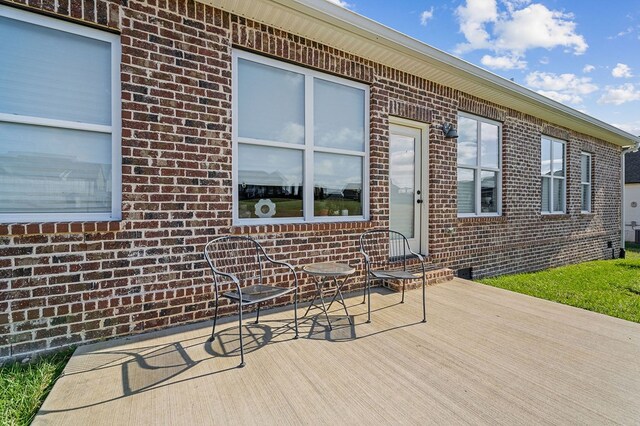 exterior space with brick siding and a deck