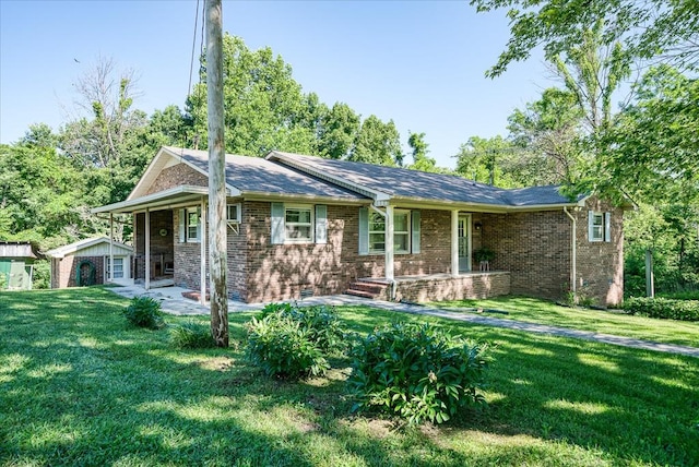 ranch-style house with a front yard and brick siding