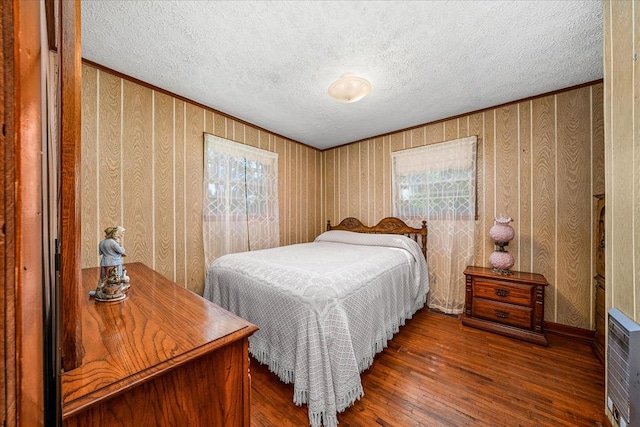 bedroom featuring dark wood-style flooring and a textured ceiling