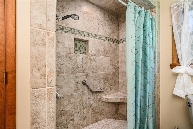 full bath featuring tiled shower