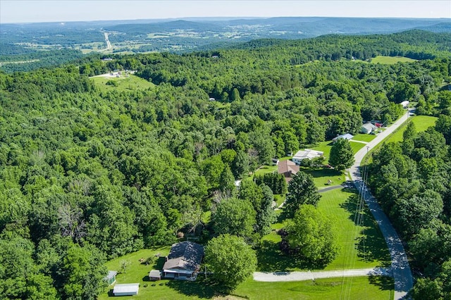 birds eye view of property featuring a view of trees