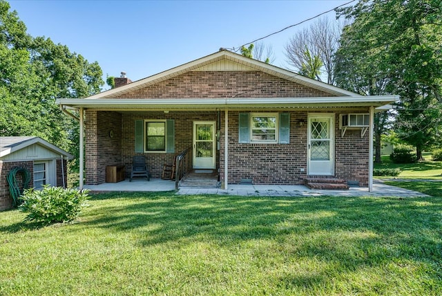 view of front of property featuring entry steps, brick siding, an outdoor structure, and a front yard