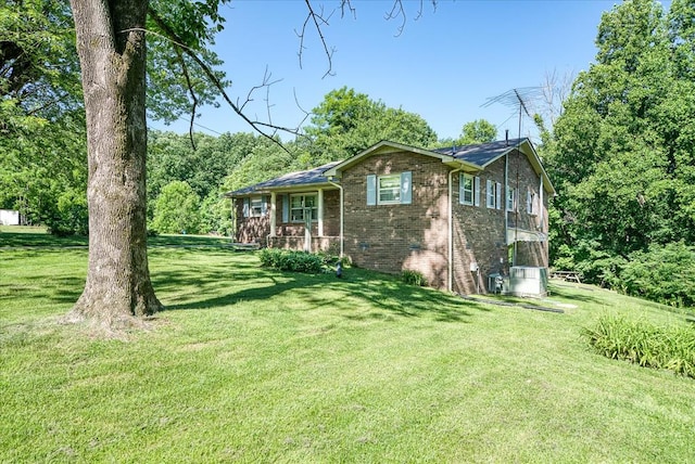 view of front of house with brick siding and a front lawn