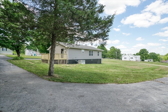 view of side of property with a lawn and central air condition unit