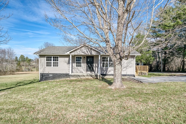 ranch-style home with crawl space, a shingled roof, and a front yard