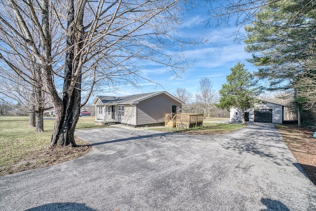 view of side of property with aphalt driveway