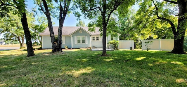 view of front of house with fence and a front lawn