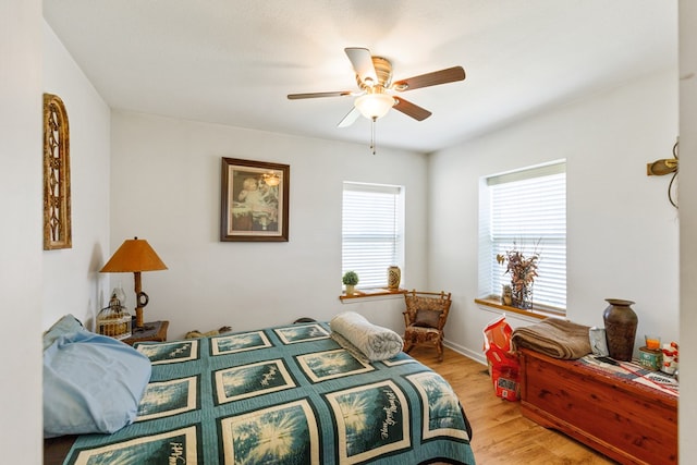 bedroom with light wood-style flooring and ceiling fan