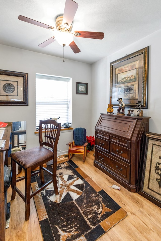 home office featuring a ceiling fan and light wood-type flooring