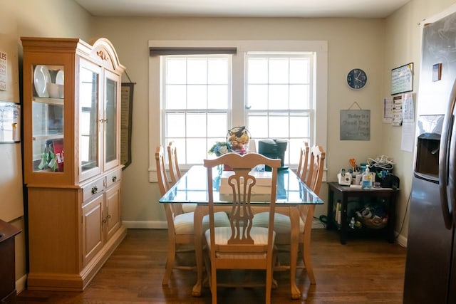 dining area with plenty of natural light, baseboards, and dark wood-style flooring