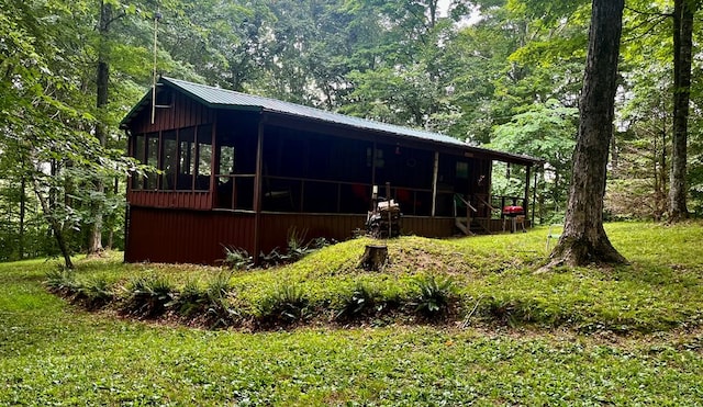 exterior space featuring a sunroom and metal roof