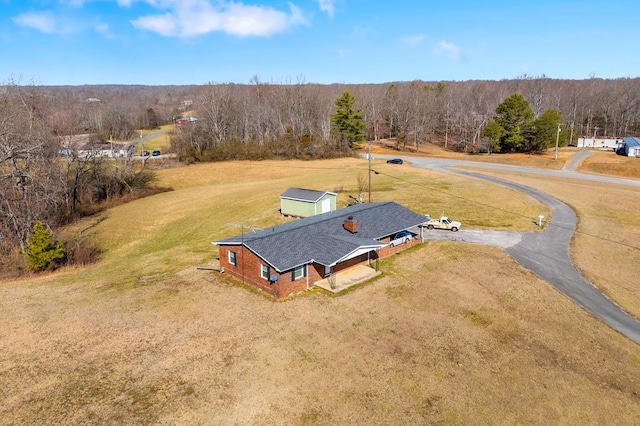 birds eye view of property featuring a wooded view