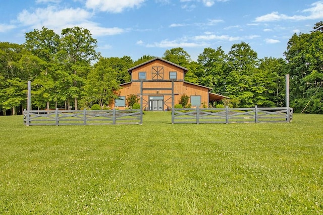 view of yard featuring an outbuilding, a barn, and fence