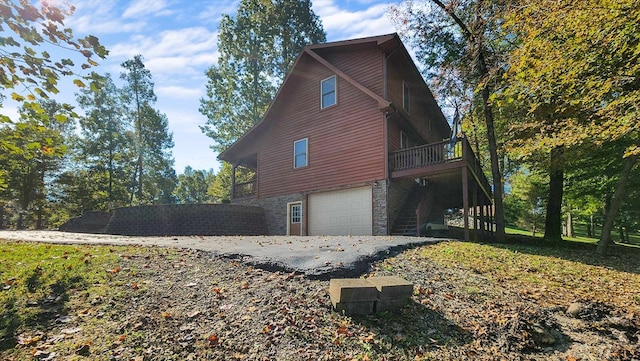 view of side of property with a garage and stone siding