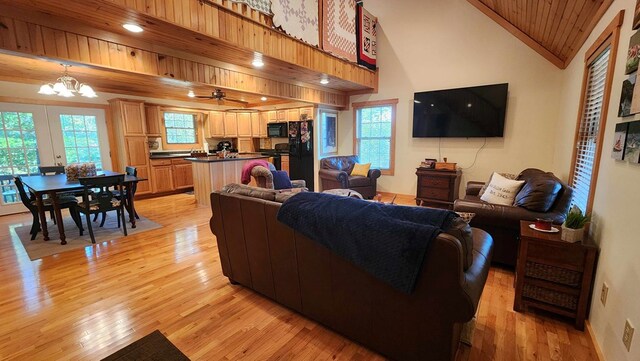 living area with light wood finished floors, recessed lighting, wooden ceiling, a notable chandelier, and high vaulted ceiling