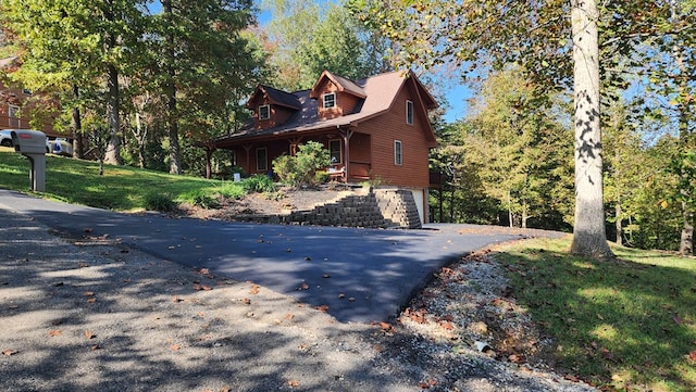 view of side of home with a lawn and a porch