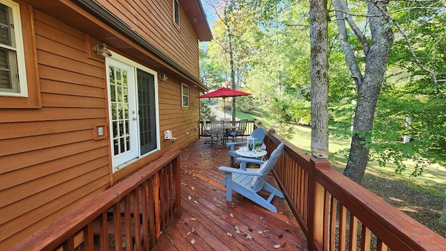 deck featuring outdoor dining space and french doors