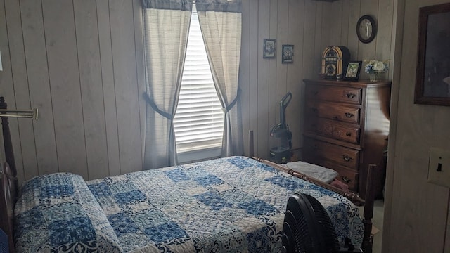 bedroom featuring wooden walls