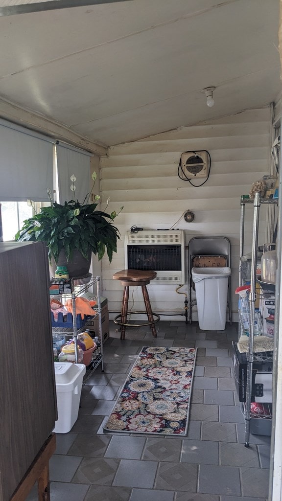 sunroom / solarium featuring heating unit