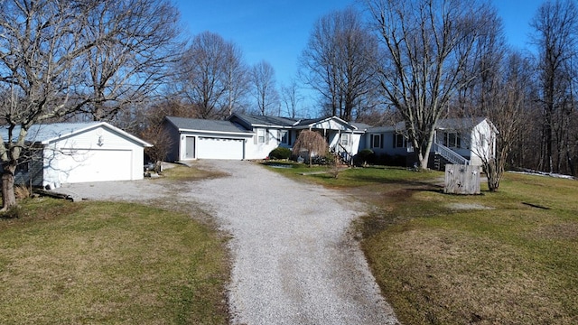 ranch-style home featuring an attached garage, driveway, a residential view, and a front lawn