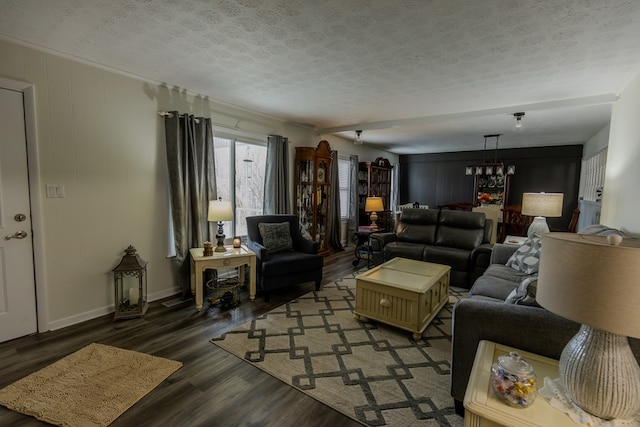 living room with dark wood-style floors, a textured ceiling, and baseboards