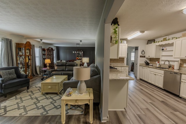 living area with a textured ceiling and light wood-type flooring