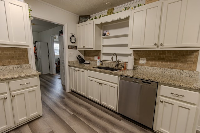 kitchen featuring white cabinets, dishwasher, light stone counters, open shelves, and a sink