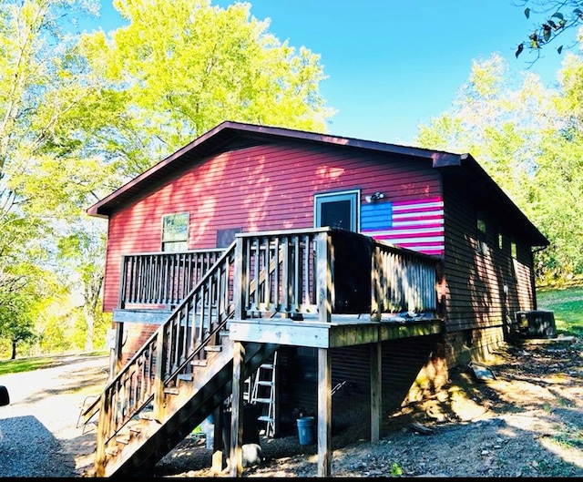 rear view of property with stairs, central AC unit, and a wooden deck