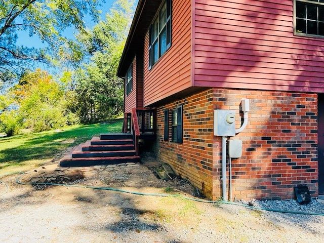 view of side of home with brick siding