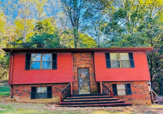 split foyer home with entry steps and brick siding