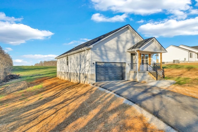 view of front of house featuring an attached garage and aphalt driveway