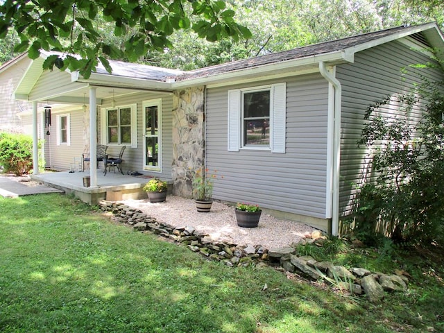 ranch-style house with a front lawn and a patio