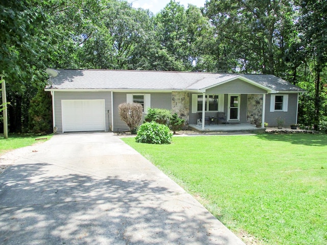 ranch-style home featuring driveway, a porch, a front lawn, and an attached garage