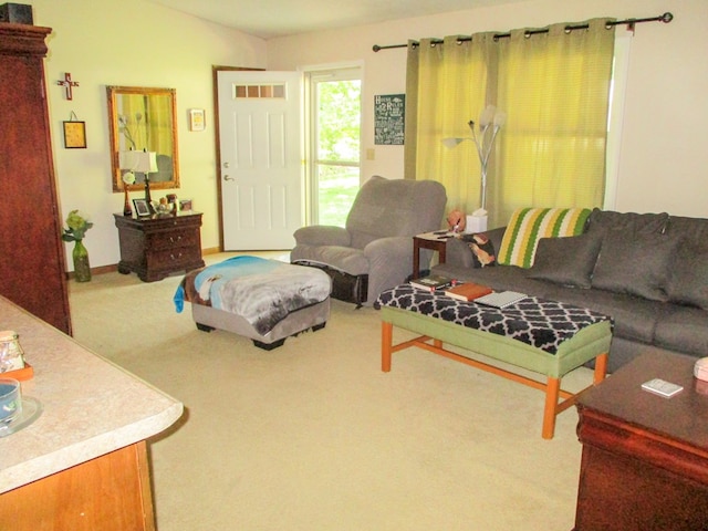 living area featuring light carpet, lofted ceiling, and visible vents