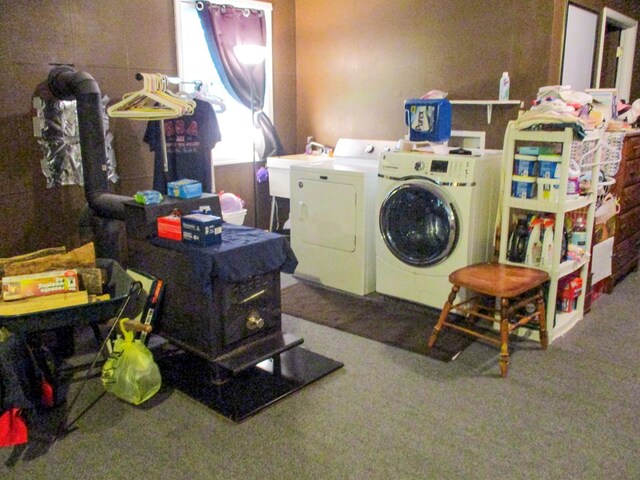 clothes washing area with a sink and washing machine and clothes dryer