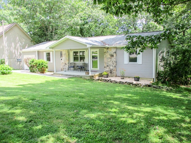 ranch-style home featuring a garage and a front lawn