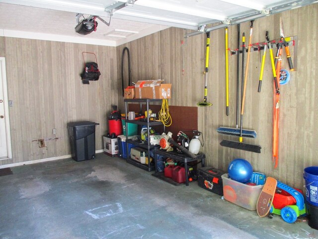 garage featuring wood walls and a garage door opener