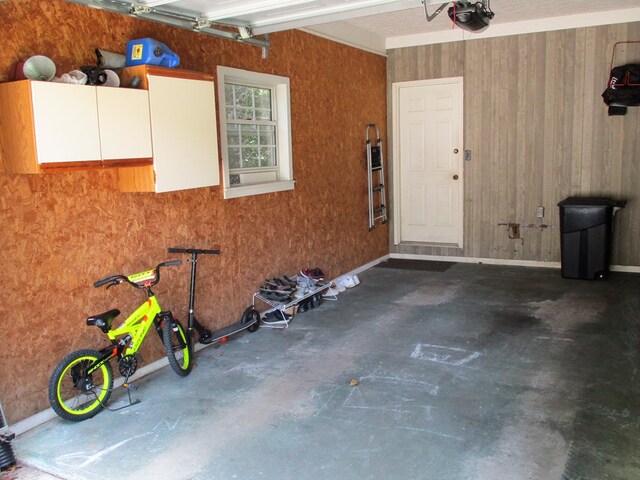 garage with a garage door opener and baseboards