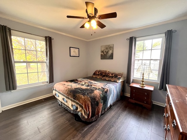 bedroom featuring multiple windows, ornamental molding, and dark wood finished floors