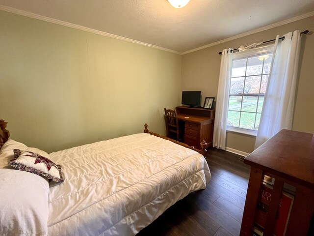 bedroom with baseboards, dark wood-type flooring, and crown molding