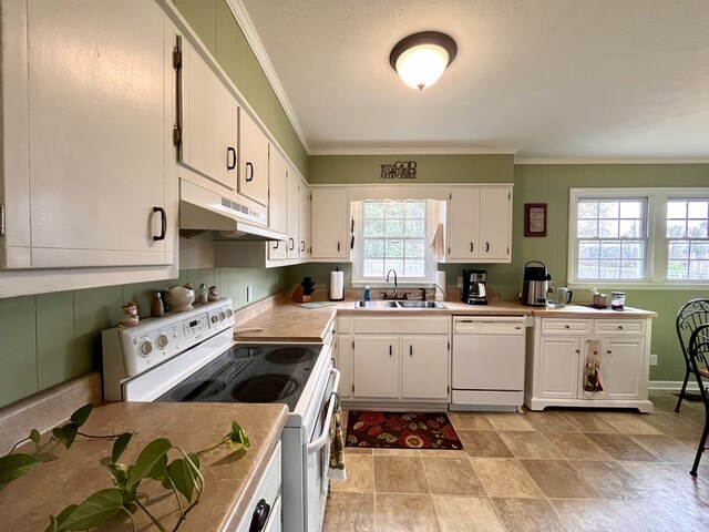 kitchen featuring light countertops, white cabinets, a sink, white appliances, and under cabinet range hood