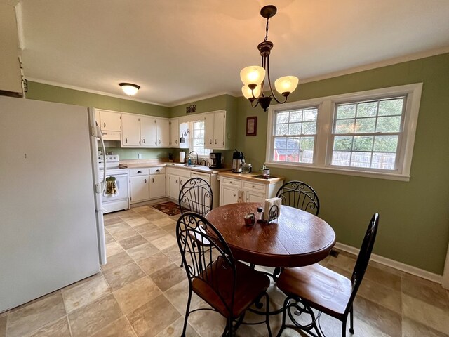 dining area featuring baseboards, a chandelier, and ornamental molding