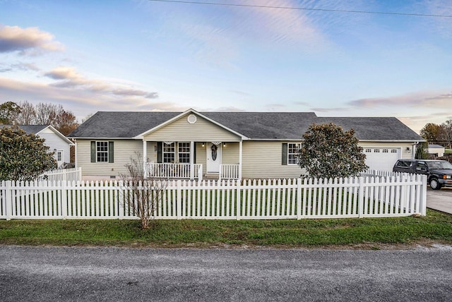 single story home with a garage, concrete driveway, and a fenced front yard